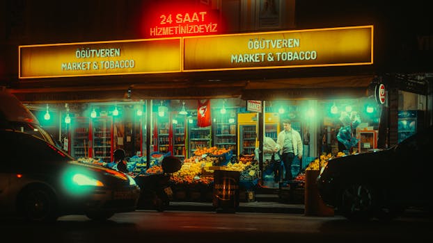 Illuminated market scene with neon lights, bustling activity, and fresh produce at night.