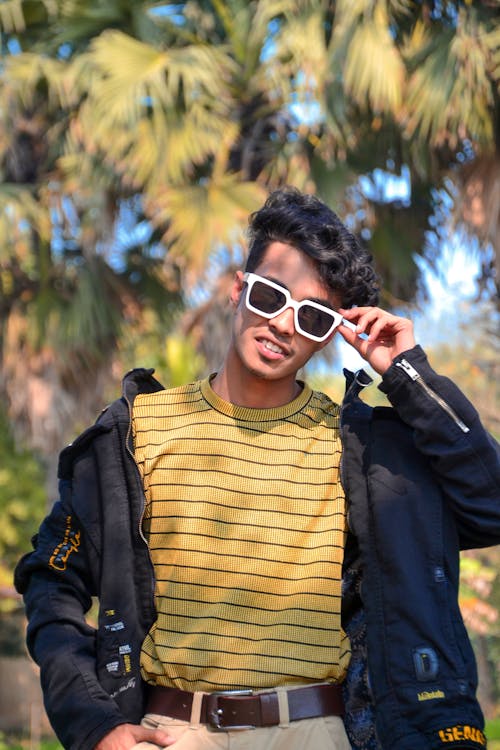 A young man in sunglasses and a striped shirt