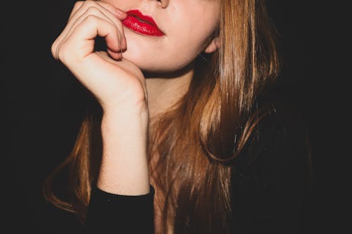 A woman with red lipstick and long hair