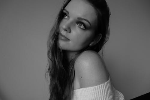 A woman with long hair posing for a black and white photo