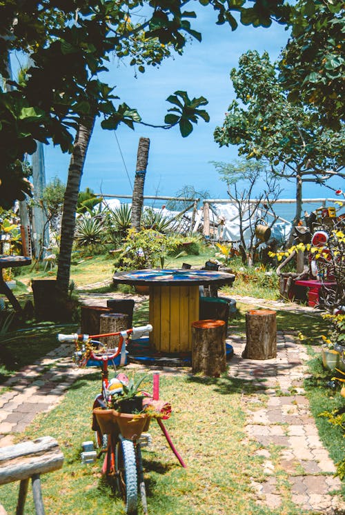 A garden with a table and chairs and a bike