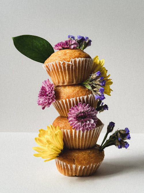 A cupcake with flowers on top and a bunch of other cupcakes