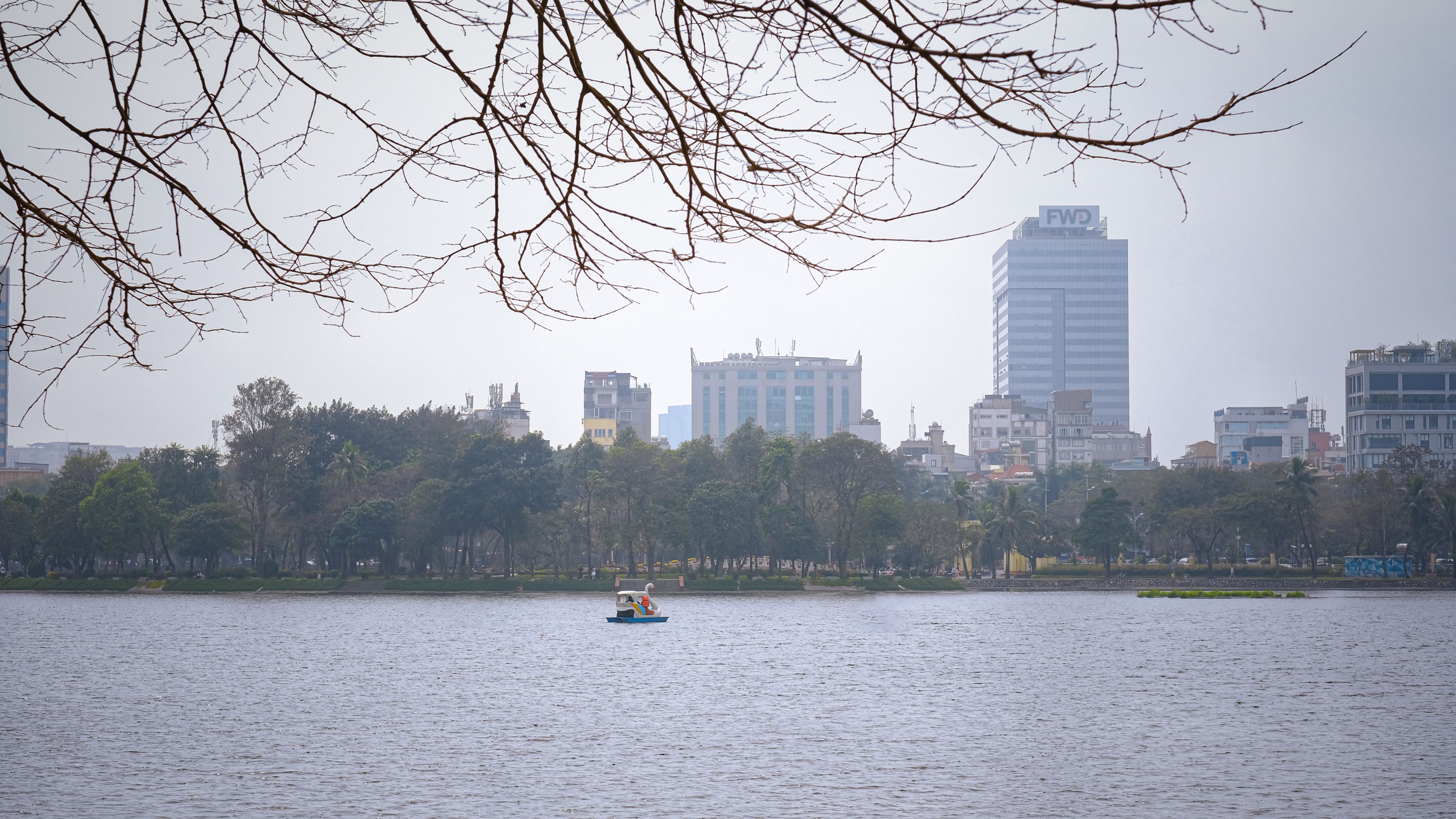 Vibrant street performances and local activities at Hoan Kiem Lake walking street during a weekend in Hanoi, Vietnam