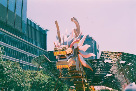 Colorful dragon sculpture in a modern cityscape, symbolizing cultural richness.