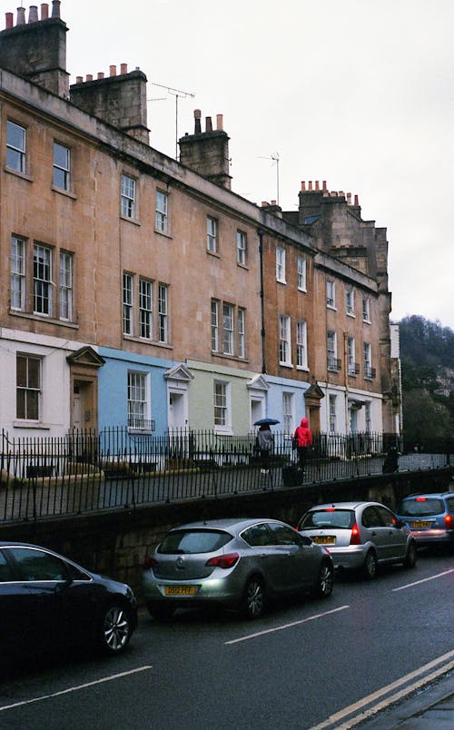 Cars Parked in Front of Brown Building