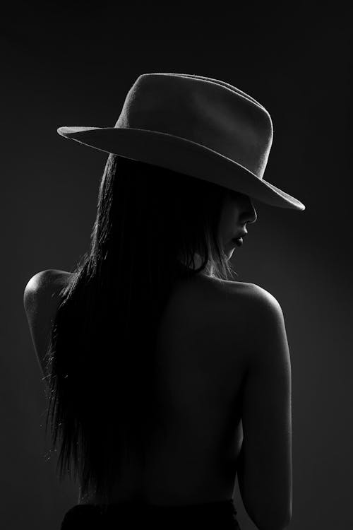 A woman in a hat is shown in black and white