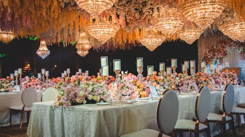 A wedding reception with chandeliers and flowers
