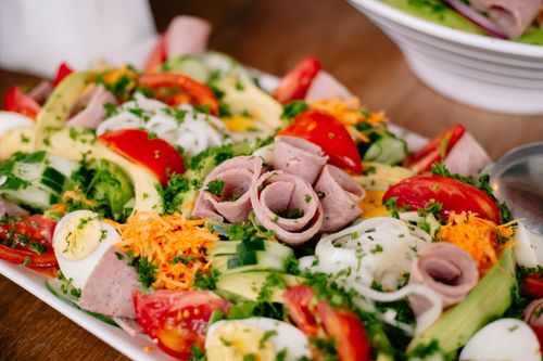 Free Vibrant salad with lettuce, tomatoes, ham, cheese, and eggs, perfect for a healthy meal. Stock Photo