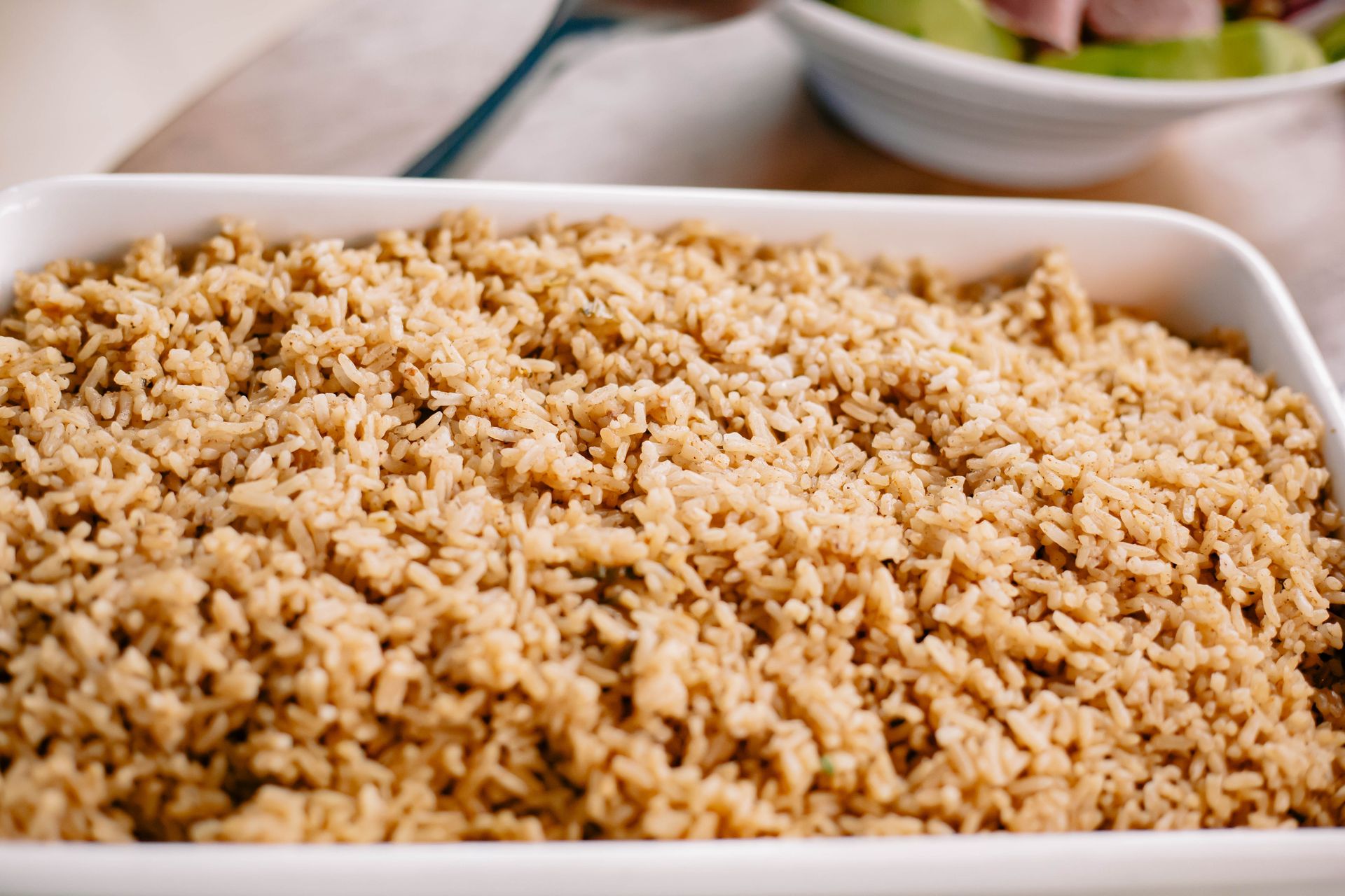 A close-up of cooked basmati rice in a white dish, perfect for lunch or dinner.