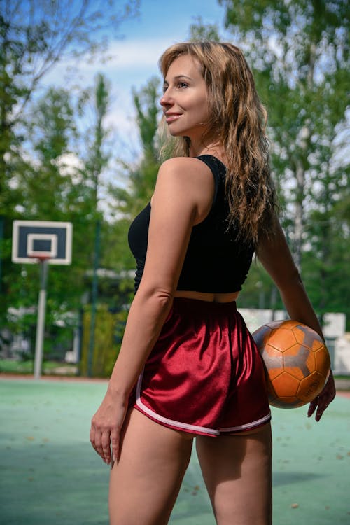 Woman in Sportswear Standing on a Basketball Court