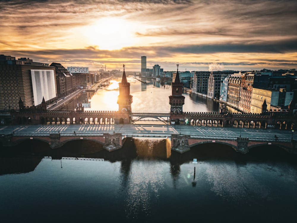 Drone Shot of the Oberbaum Bridge Crossing the River Spree in Berlin, Germany at Sunset