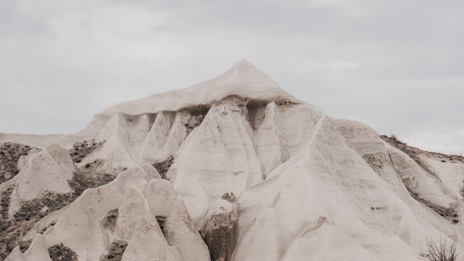 Breathtaking view of Cappadocia's unique and majestic rock formations under a cloudy sky.