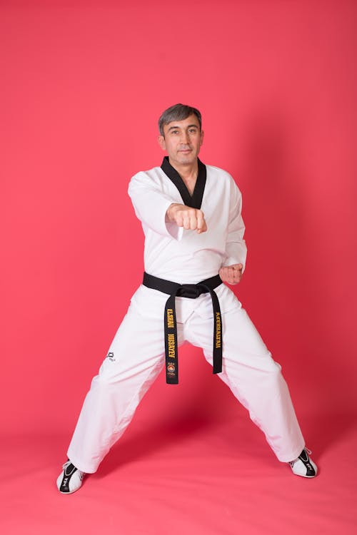 A man in black and white karate gear posing