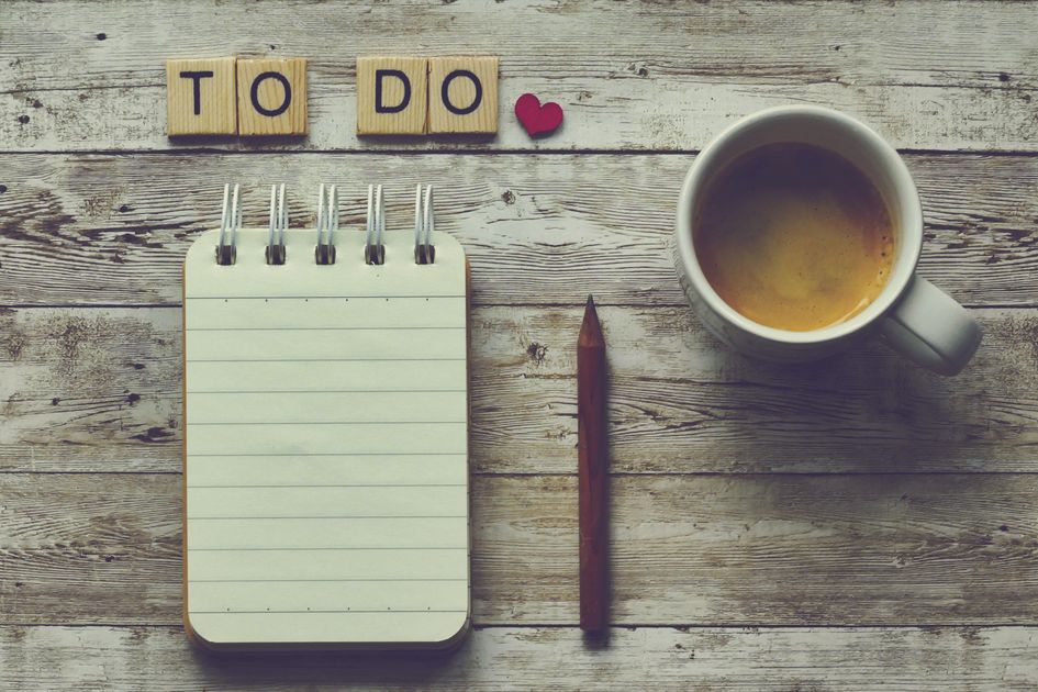 An open notepad with a pen resting beside a morning coffee, ready to hold a single written sentence.
