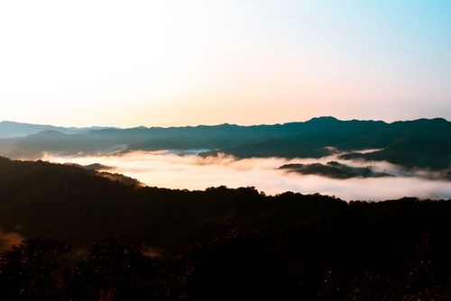 Free Beautiful sunset view of misty mountains in Taipei, Taiwan, with golden and blue hues. Stock Photo