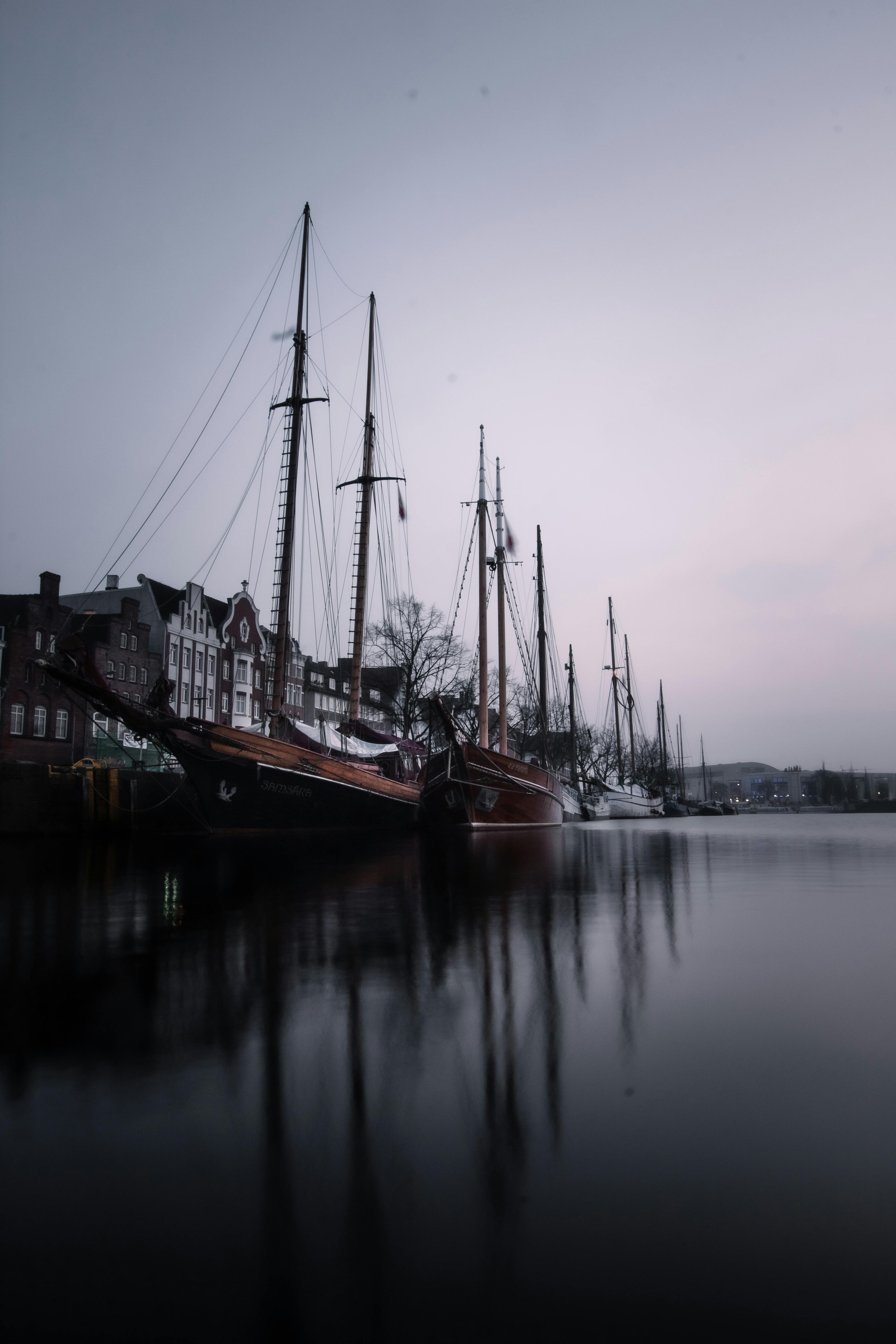 Explore the serene beauty of moored ships against the historic Lübeck waterfront.
