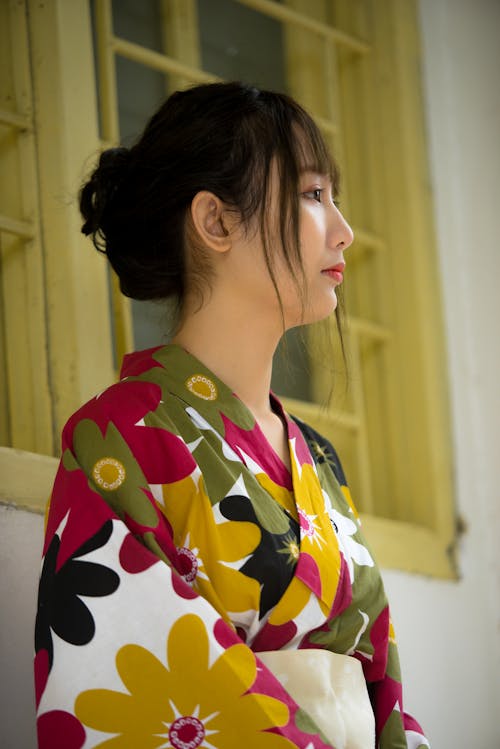 Woman in Red, Green, and Yellow Floral Dress