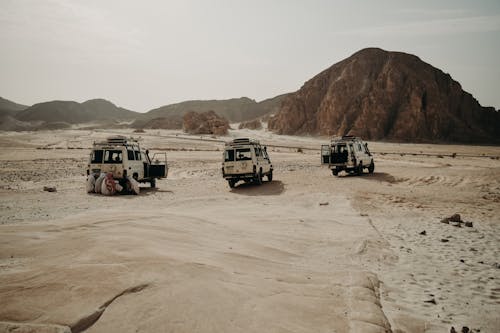 Men Repairing an Off-road Vehicle During an Expedition Through the Desert