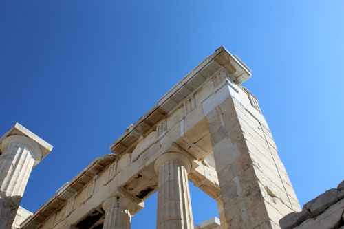 Free Close-up view of ancient Greek temple columns under a clear blue sky. Stock Photo