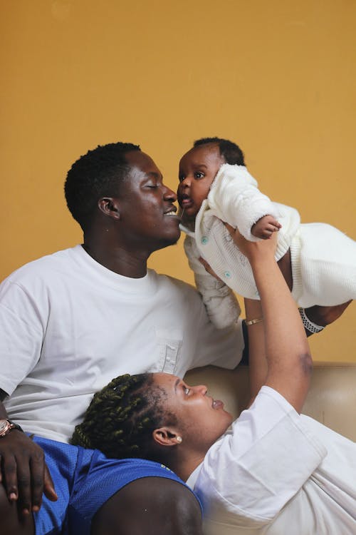 A man and woman holding a baby in their arms