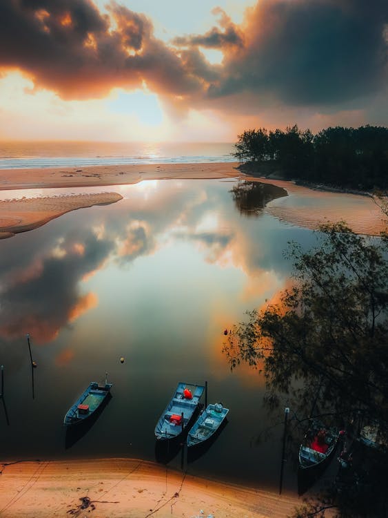 Sun Setting over Boats Moored on a Lakeshore