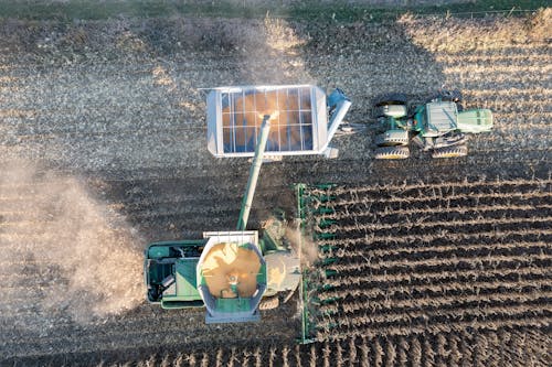 An aerial view of a combine harvesting a field