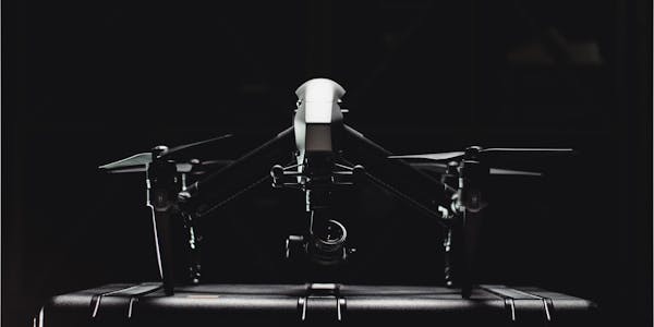 Police drone scanning urban street from above