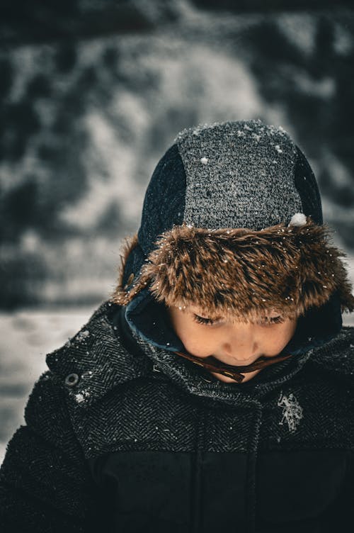 A child wearing a winter jacket and hat