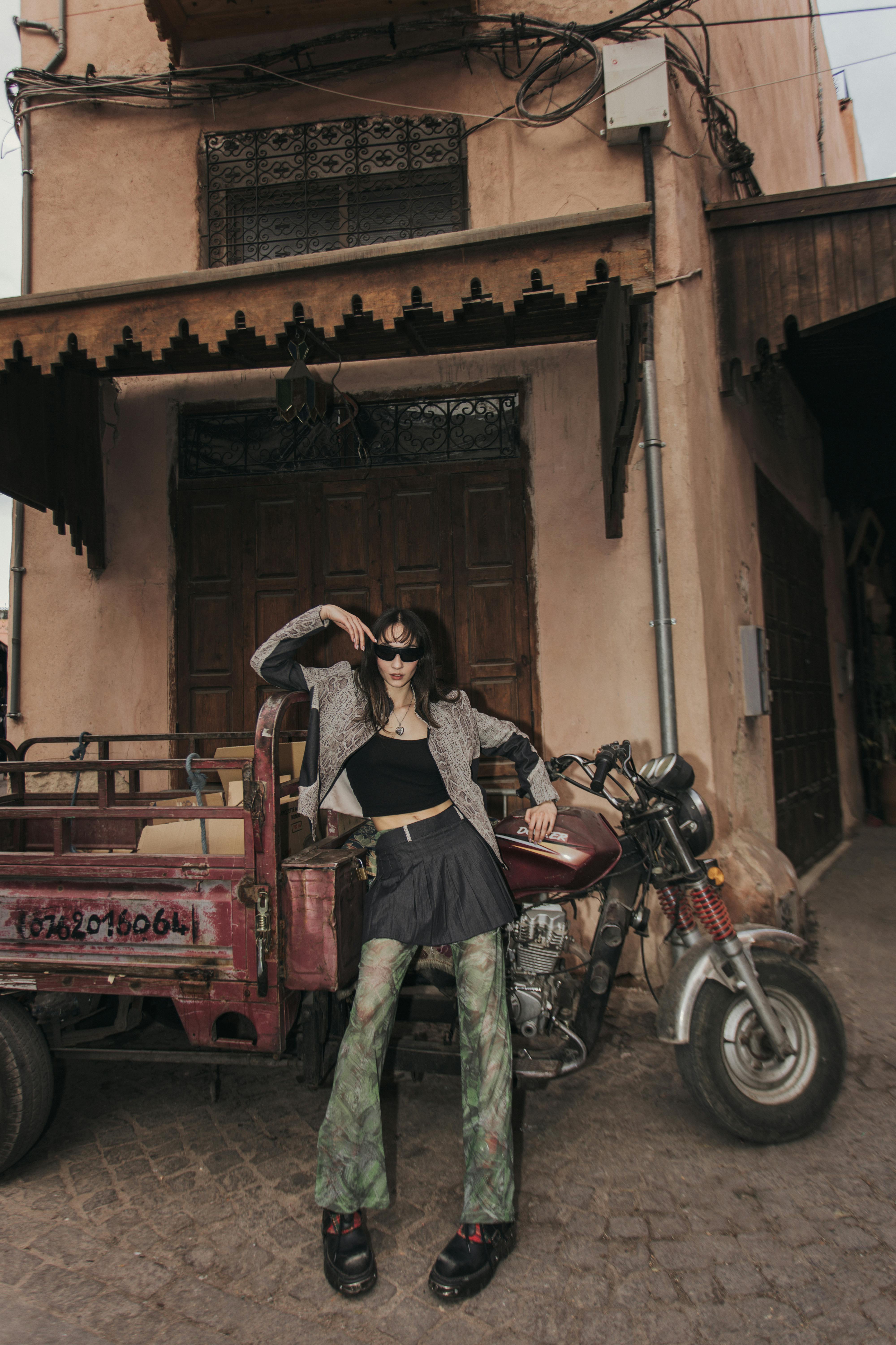 woman leaning on motorbike