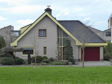 Contemporary house in suburb with vibrant yard and garage.