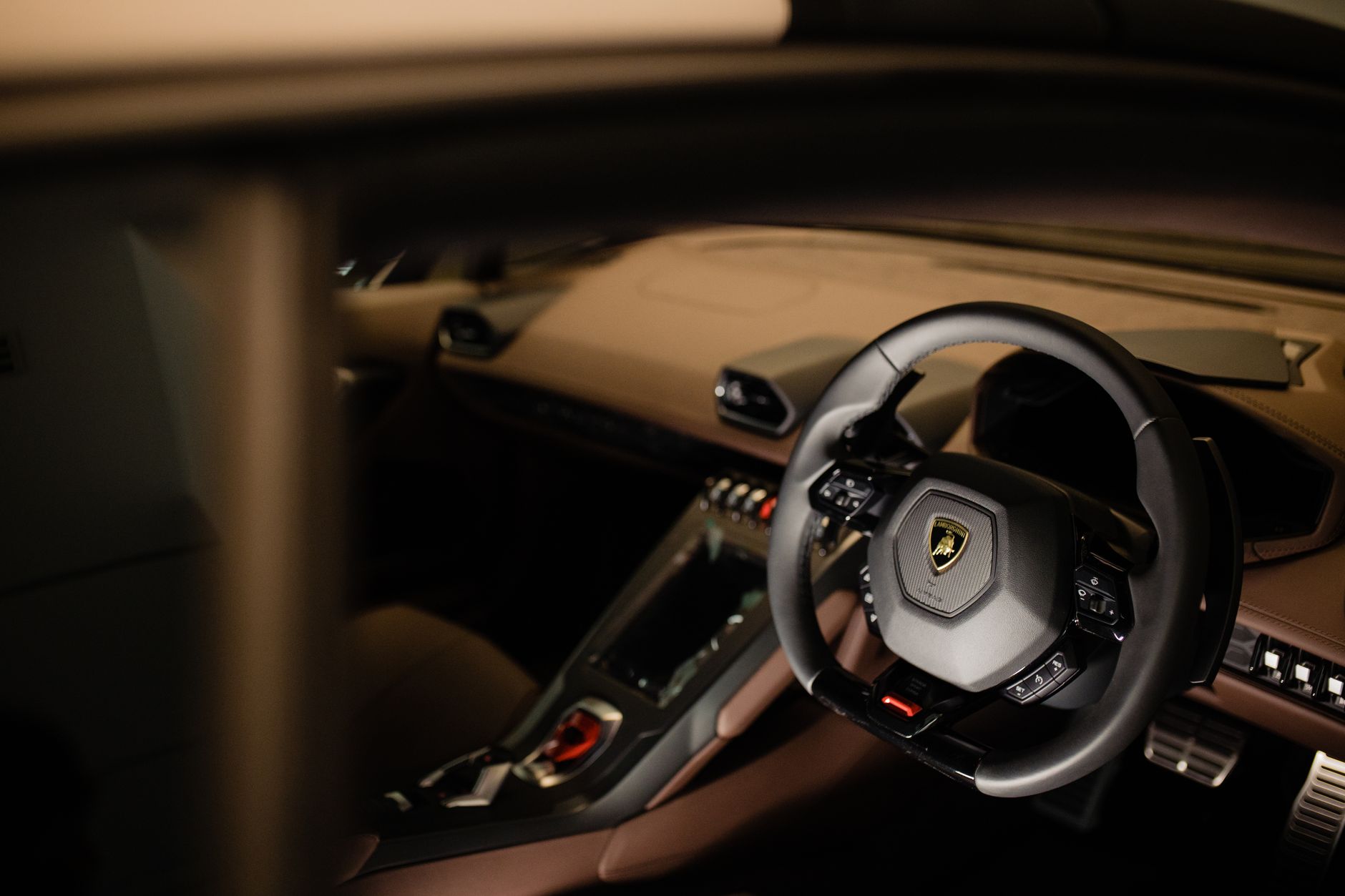 Explore the sleek interior of a Lamborghini Huracan, showcasing its modern dashboard and steering wheel.