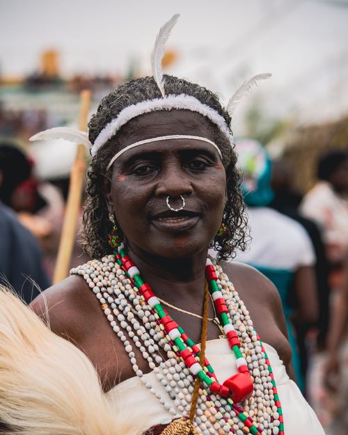 Free A vibrant portrait of a woman in traditional attire with jewelry at a Nigerian festival. Stock Photo