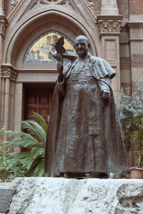 A statue of pope benedict in front of a church