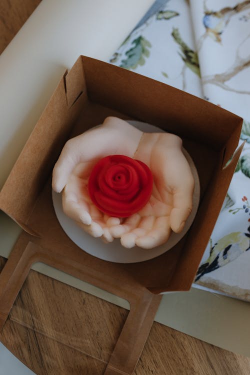 A box with a rose on top of it