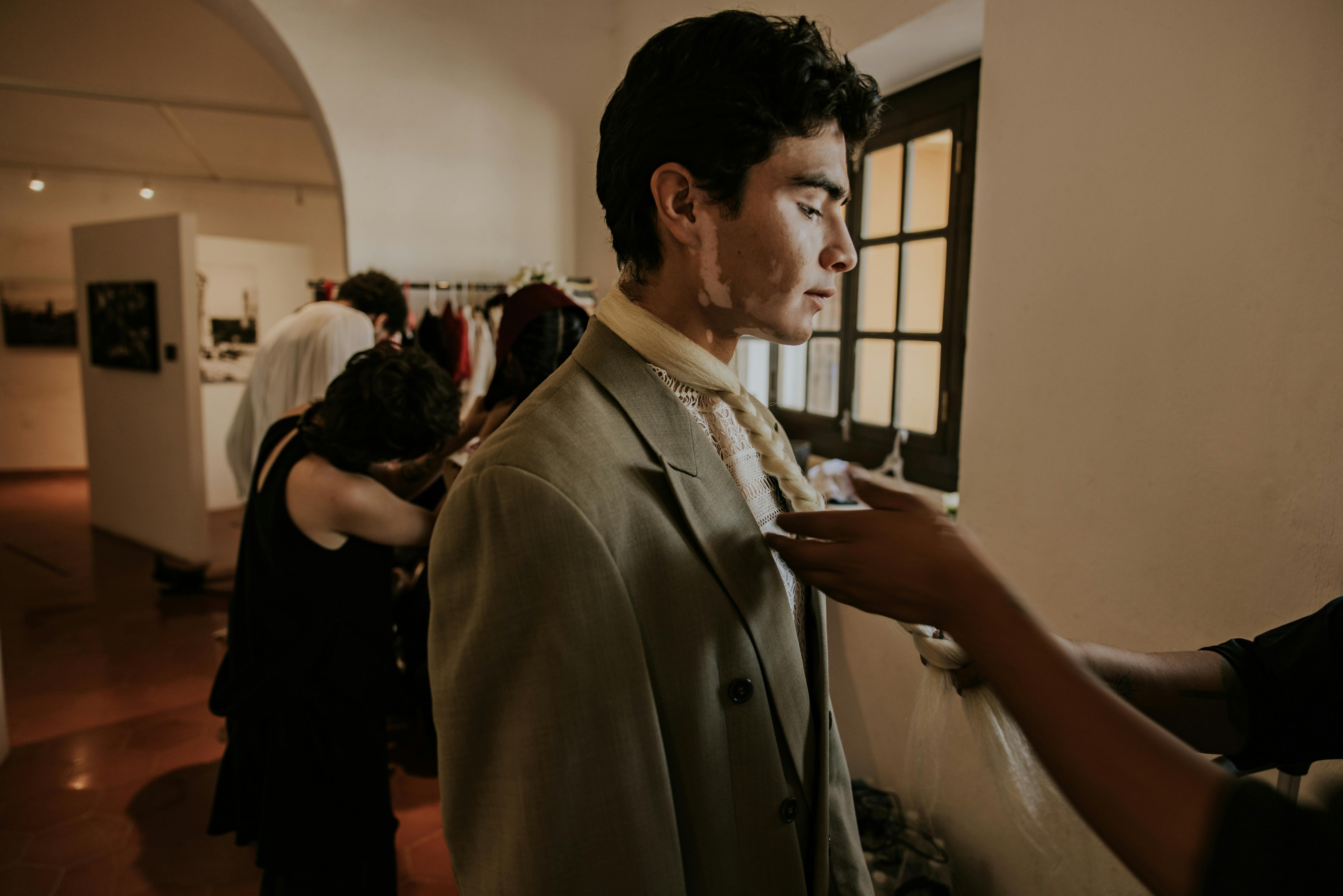 elegant man getting dressed for a photoshoot