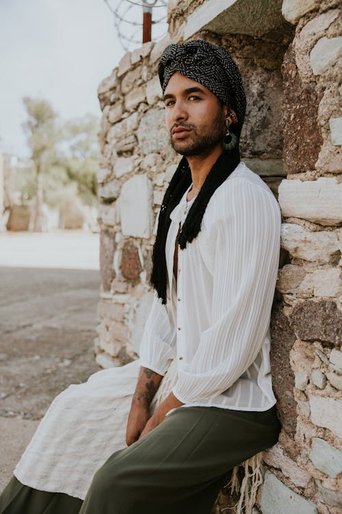 Model in a Black Headwrap White Striped Shirt and Olive Green Pants