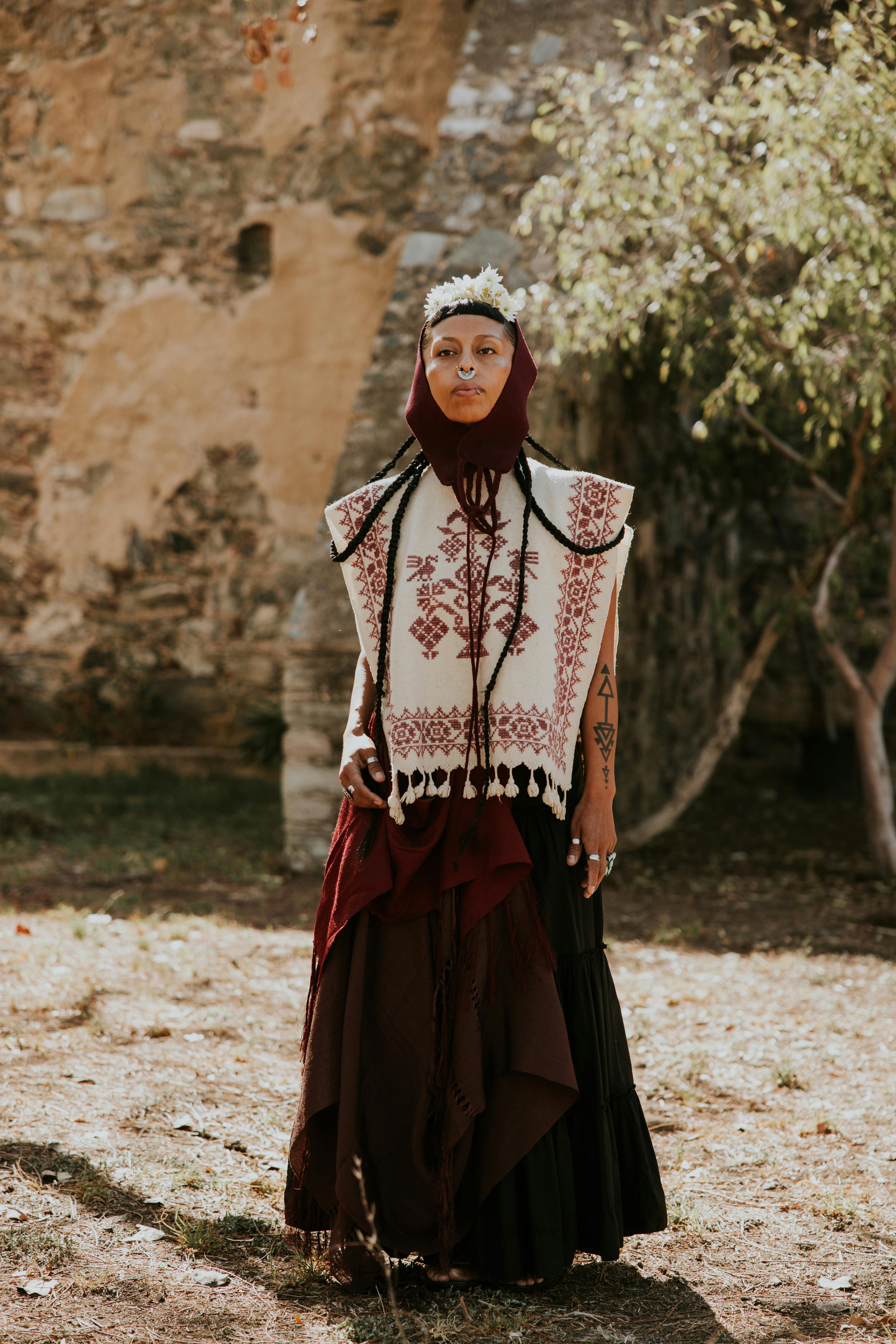 Woman in traditional Mexican clothing poses outdoors in Guanajuato, capturing cultural essence.