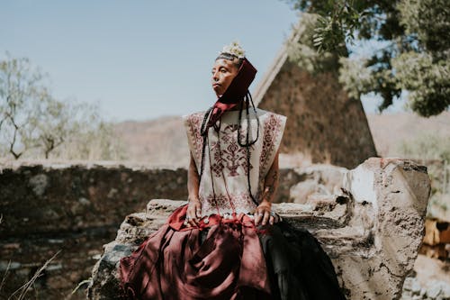 Woman Sitting in Traditional Clothing 