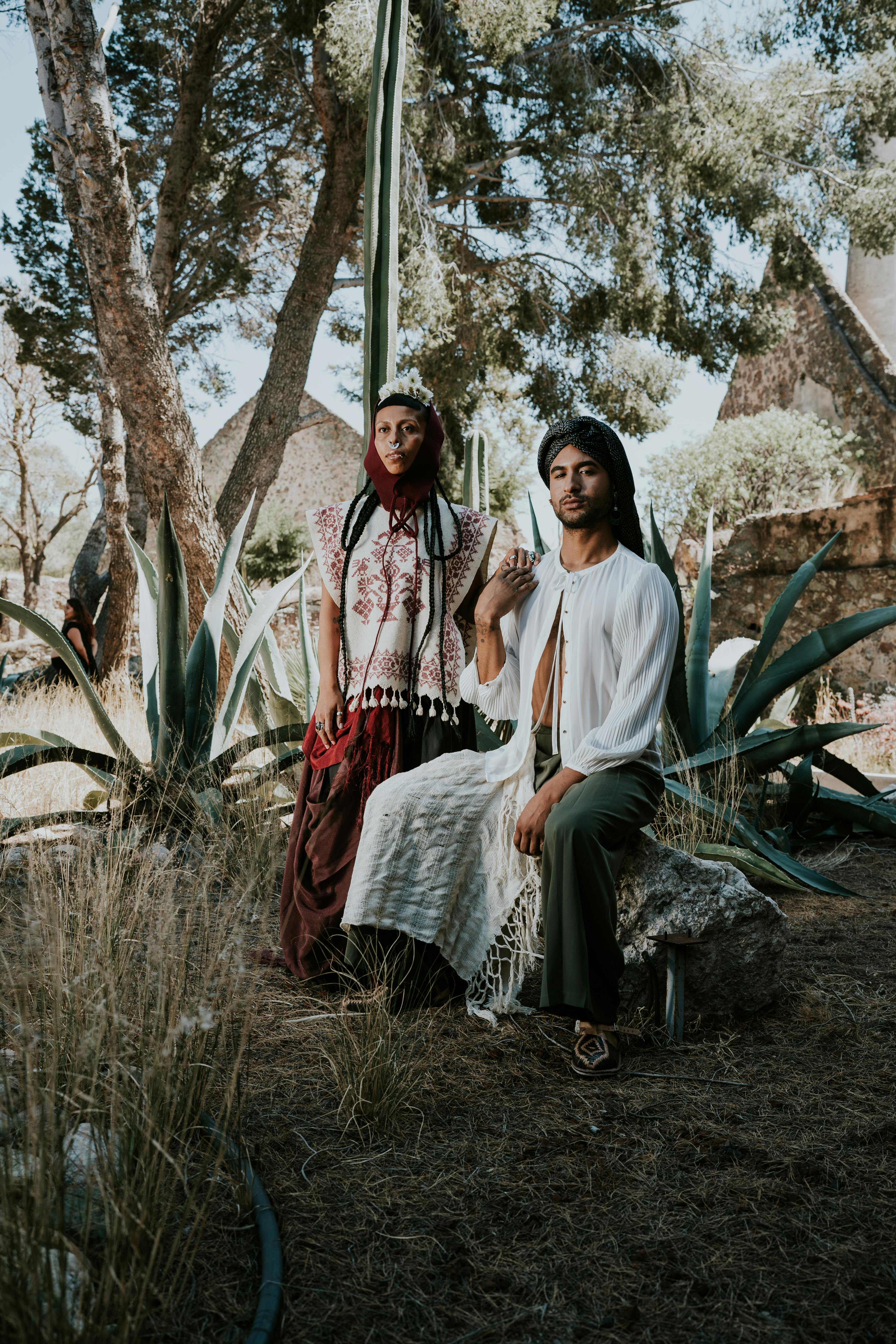 A man and woman in traditional clothing pose among agave plants in Guanajuato, Mexico.