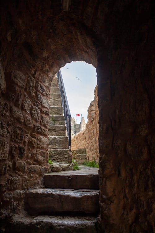 View of a Narrow Walkway between Stone Walls of a Castle 