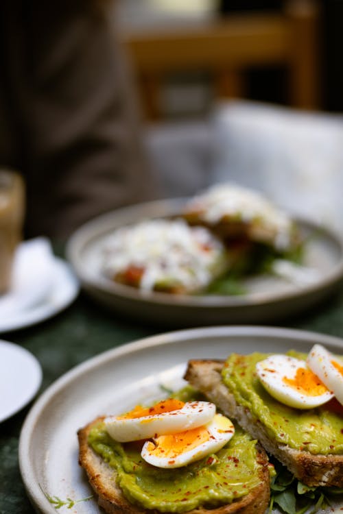 A plate of food with avocado and eggs on it