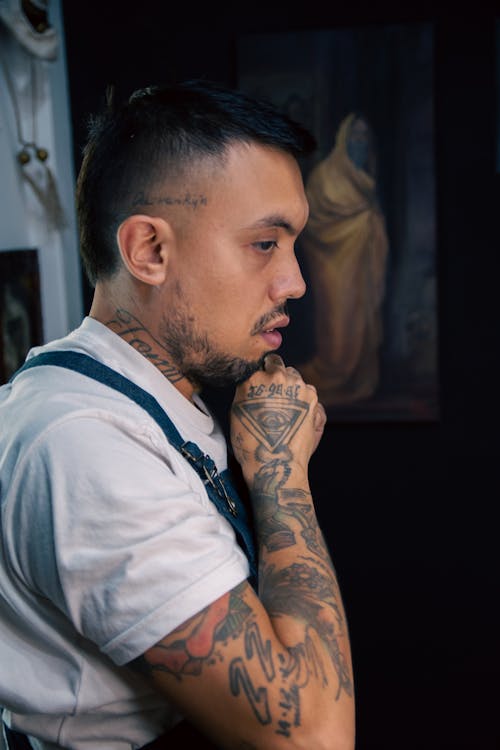 A man with tattoos on his arm and a tattoo on his arm