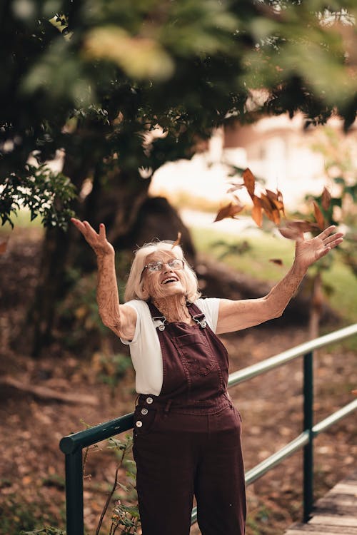 Woman Wearing Brown Overalls Near Brown Tree