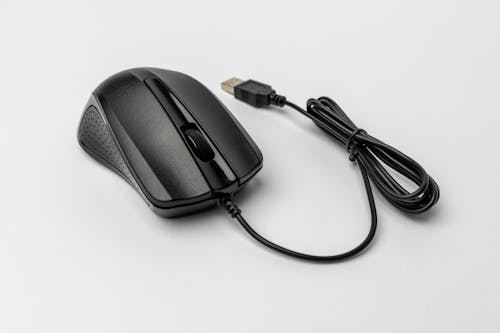 A black mouse with a cord attached to it