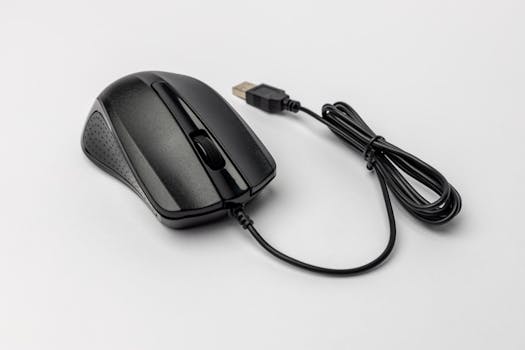 Black ergonomic USB computer mouse with cable on a white background, perfect for office use.