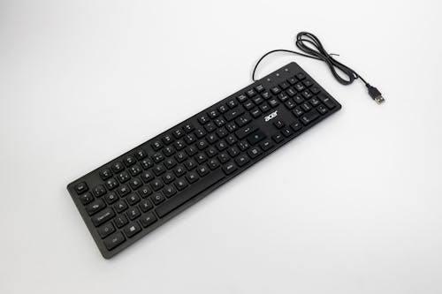 A black keyboard with a cord attached to it