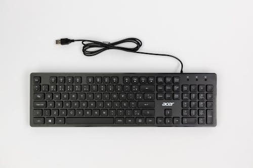 A black keyboard with a cable attached to it