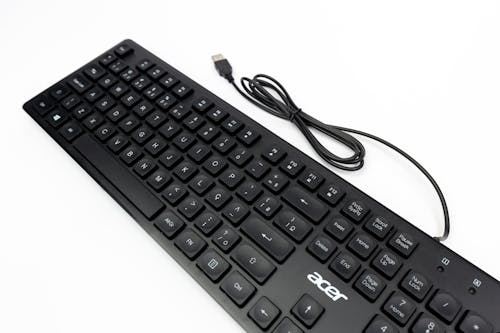A black keyboard with a cord attached to it