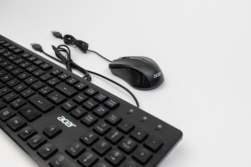 A black keyboard and mouse on a white surface