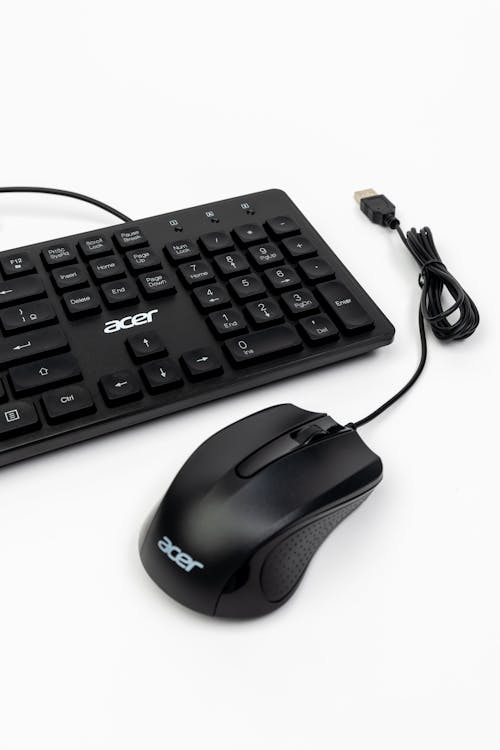 A black computer mouse and keyboard on a white background